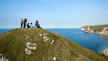 The production team filming at Lulworth Cove