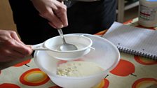 Sieving the meadow sweet infused cream