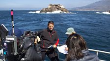 Steve gets ready for a piece to camera on the Fulmar with Lobos Rocks in the background