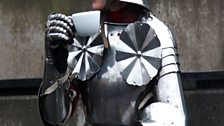 Lucy in armour at Leeds Armoury, watching jousting