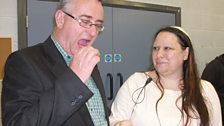 Sharon Lough of the Jewish Community offers Liam a taste of a pretzel