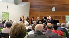 The audience enjoying listening to choral group, Melisma