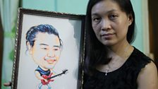 Human rights activist Mae Sabe Phyu and a picture of her husband, Patrick Kum Jaa Lee, who's in jail.