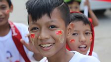 Young supporter at NLD rally near Yangon waiting for Aung San Suu Kyi