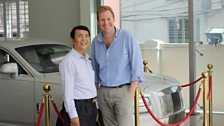 At one of many new car dealerships in Yangon My Zaw Aung is happy to sell you the Rolls Royce behind him for $500,000!