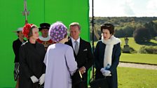 The actors rehearse a scene in front of the green screen.