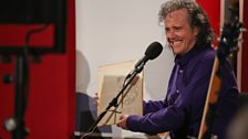 Donovan holding up his original vinyl album "Sunshine Superman"