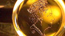 Portrait of the Queen engraved on a speck of gold in the eye of a needle