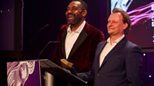 Actor, Neil Stuke presents a prize