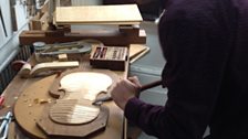 Carving the arched front of a violin by hand and eye