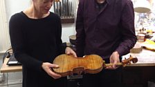 Andreas shows Verity the 'flame' on the back of his latest violin