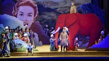 King Ouf (Christophe Mortagne) introduces his pet elephant as Lazuli (Kate Lindsay) sits in the foreground