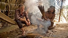 Hunter, Bai, shows Gordon how to prepare poison darts by tipping them with curare