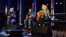 Red Sky July performing on stage in the Pacific Quay foyer