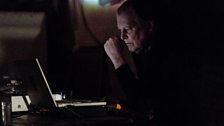 Autodidact electronic composer John Wall performs on laptop in total darkness