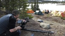 Cameraman Johnny Rogers films Liz Bonnin with caribou scientist Mike Suitor at Sheep Creek base camp