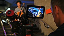 Sheku Kanneh-Mason is filmed in the foyer of the Barbican Centre by cameraman Paul for the TV broadcast