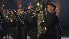 Tuba player performing with his brass family