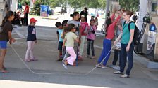 NGO volunteers and refugee children at the EKO petrol station