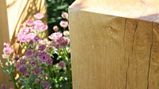 Two oak character posts stand at opposite corners of the garden symbolising people destined to meet.