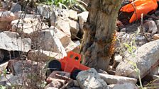 Toys and life jackets that were found washed up on beaches in Greece are strewn around the garden.