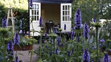 A raised bespoke summerhouse serves as a place to relax and reflect and offers another perspective to the garden.