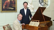 Duke of Buccleuch at Handel's harpsichord, with curator Paul Boucher at Boughton House.