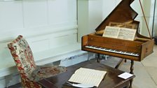 Handel's harpsichord as part of Handel at Boughton, with a portrait of G.F. Handel.