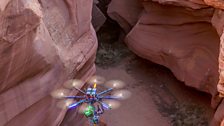 Piloting a large, remotely operated drone through the narrow walls of a slot canyon.