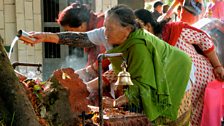 A women gives an offering at the Indrayani temple, Bhaktapur