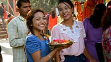 Women present their puja, offerings of rice and flowers for the gods