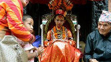 A young boy brings an offering to Patan's current kumari