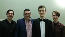 The three young musicians with presenter John Toal