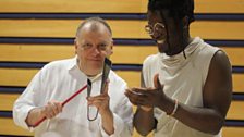 Robert Worby learns how to play the agogô under the watchful eye of Alysson Bruno