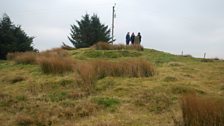 On top of the burial cairn