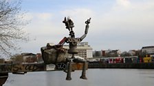 A small metal sculpture hanging over the river at Yaam