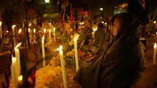 At a cemetary in Oaxaca, villagers light candles