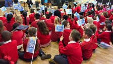 Cardwell Primary pupils wave flags at their Ten Pieces Assembly