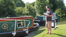 Richard presents by a passing boat