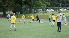 Owen playing football with pupils at St Louis’ Grammar School, Ballymena