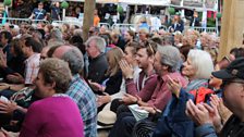 A very happy looking audience in the sun shine