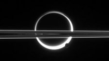 Tiny Enceladus against the giant Titan and the rings