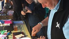 Simon Nicol cuts Fairport Convention's 50th Bithday cake backstage at Cropredy Festival 2017