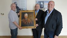 Mac Pollock, Alec Blair and Willie Hill with a painting of George Shiels