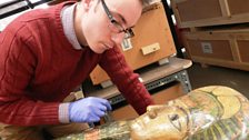 Campbell examines an Egyptian sarcophagus