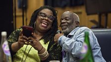 Cecilia Noble (Mrs Dunwoody) and Joseph Marcell (Narrator) laughing