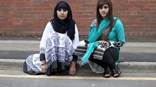 Sisters sitting on kerb