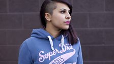 Blue hoodie, pink lipstick shaved head