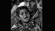 A man and his son wait for aid at Kutupalong refugee camp