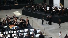 Conductors confer during rehearsals.